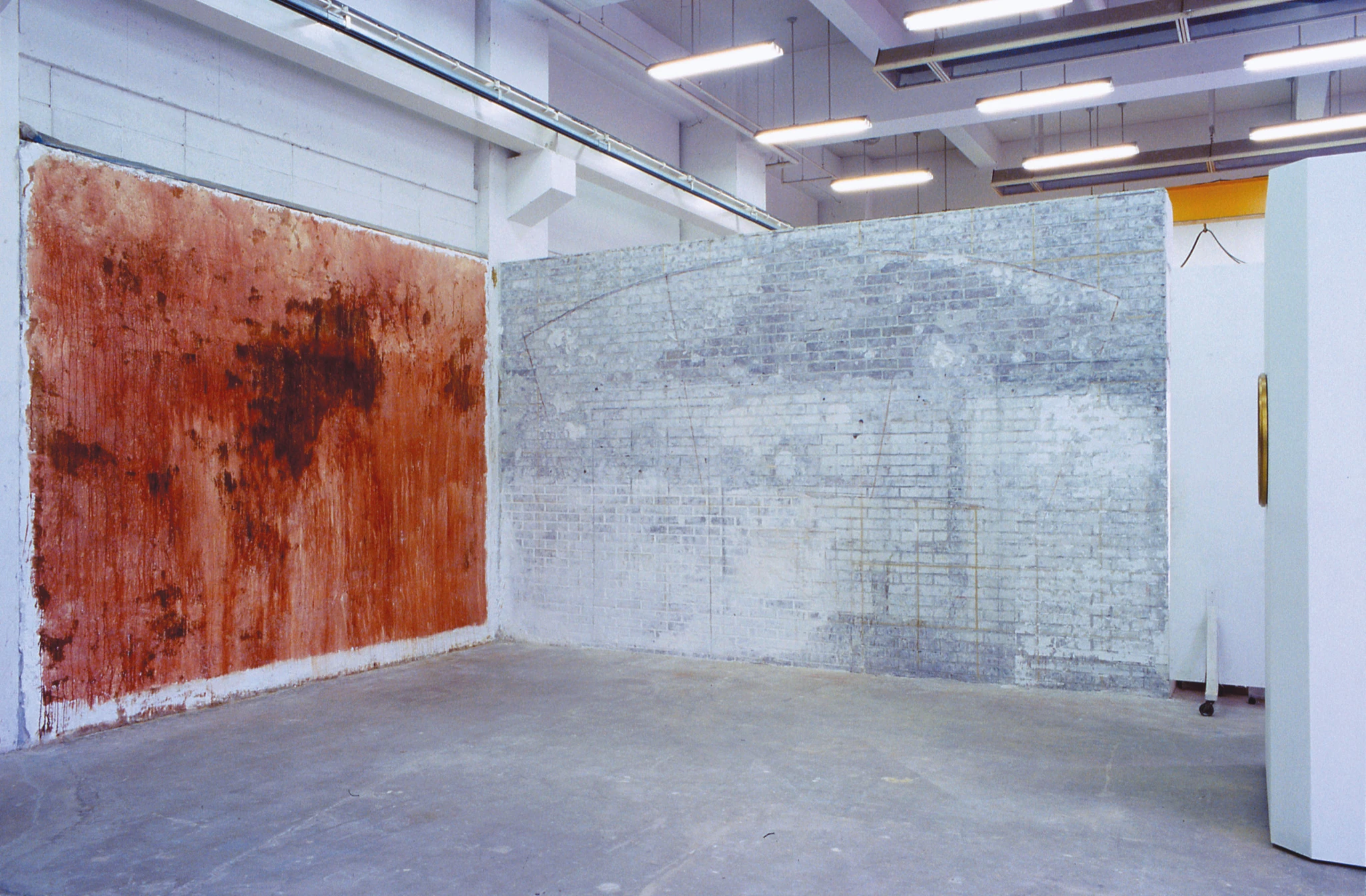 Installation view of Blood Wall Blood Mirror with the blood-coated wall, fresco studio wall, and framed mirror, 2003