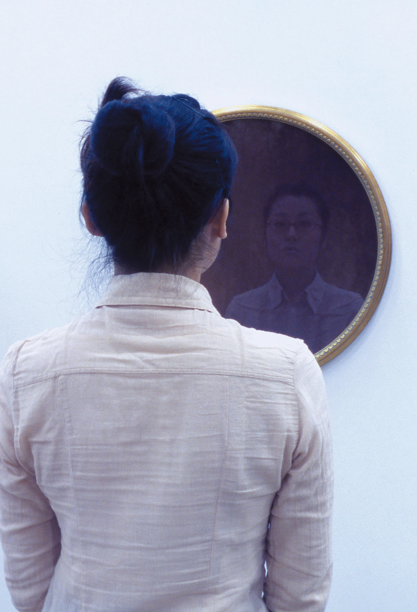 Close view of a viewer reflected in the circular mirror