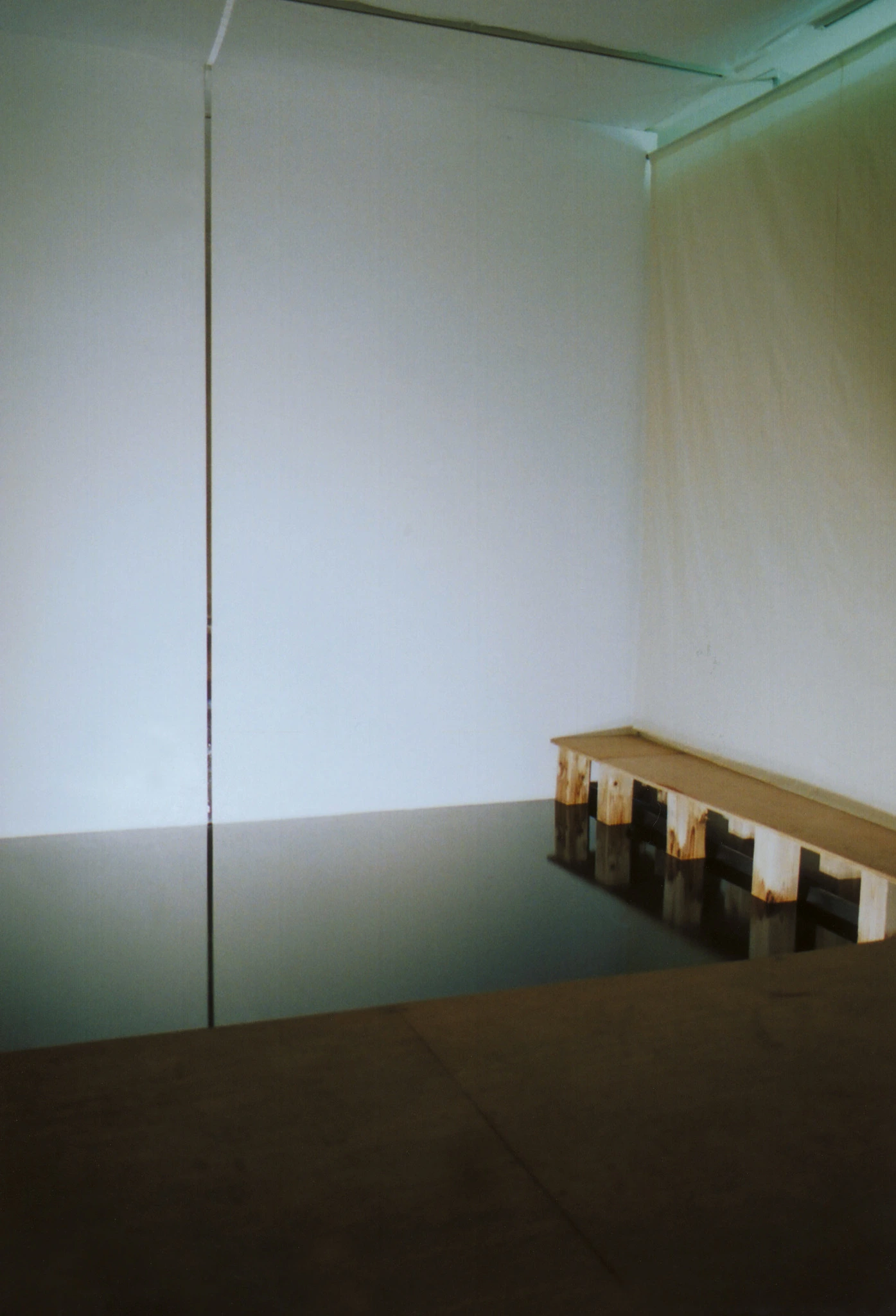 Epilogue-like installation view of the reflective plane and bench after the passage