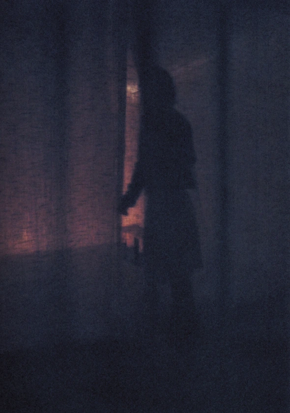 A figure passing through the curtain