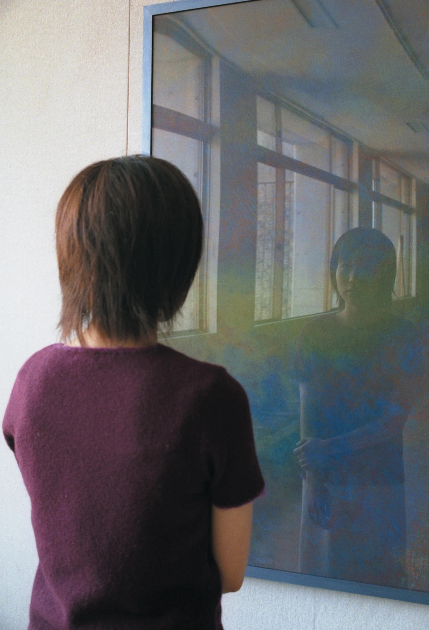 A viewer standing before Every Colour You Are as her reflected image enters the color field