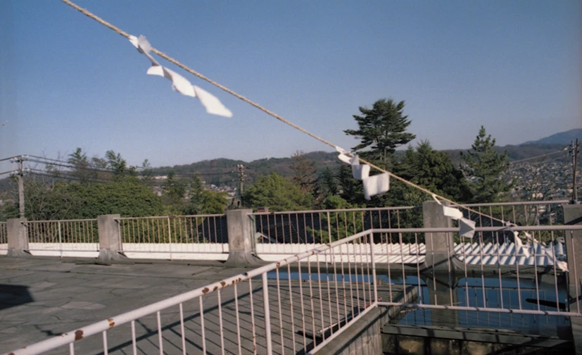 Rope and paper gohei crossing an open rooftop
